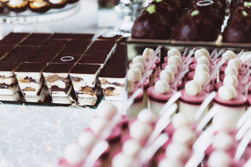 Assortment of pieces of cake on messy table