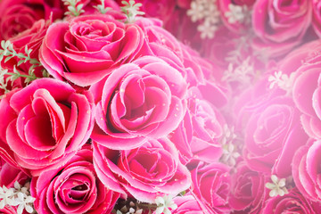 Pink floral background. Lot of artificial roses in colorful composition.