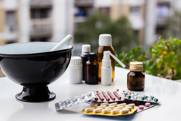 Mortar and pestle with pills and pill bottles 