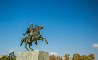 Alexander the great sculpture of famous historical character on clear empty blue sky background...