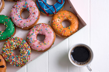 Colorful Donuts with Coffee in White Backdrop