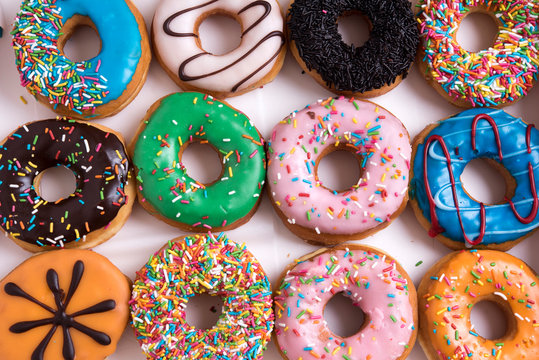 Colorful Donuts with Coffee in White Backdrop
