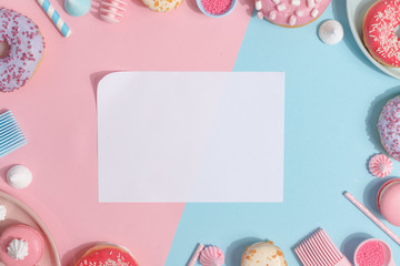Kitchen utensils and tools, pastries and sweets on a pink and blue background. Top view. Copy space.