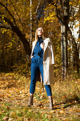 A beautiful blond girl in an autumn park