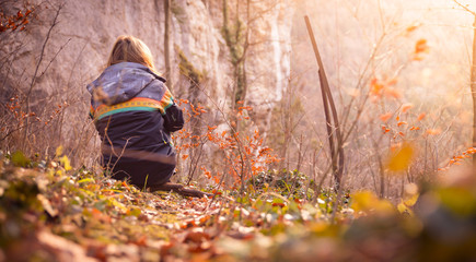 Young girl enjoys the mountain view, beautiful scenery with sundown, autumn