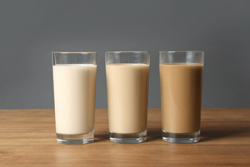 Glasses with protein shakes on wooden table