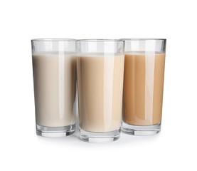 Glasses with protein shakes on white background