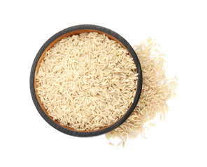 Plate with raw unpolished rice on white background, top view