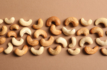 Tasty cashew nuts on color background, flat lay