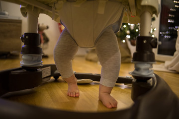 Babys feet in a baby walker
