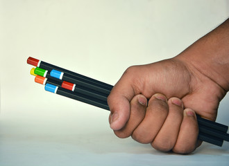 Fototapeta premium Bunch of pencils holding in hand with white background