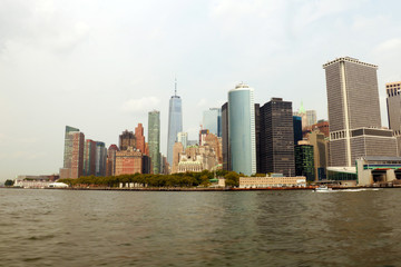 Fototapeta na wymiar NEW YORK, USA - August 31, 2018: Panoramic view of Manhattan Island with modern buildings and Hudson river. Scenery skyline view of contemporary glass skyscrapers of downtown financial district 