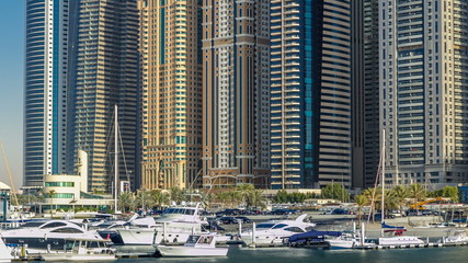 Obraz na płótnie Canvas Close up View of Dubai Marina tallest Towers in Dubai at day timelapse