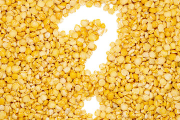 Yellow split dried peas, question mark, isolated, close up, macro, top view. Healthiest nutritious...