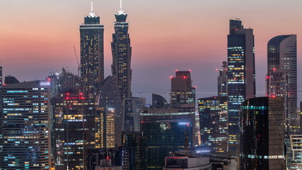 Fototapeta na wymiar Scenic aerial view of a big modern city day to night timelapse. Business bay, Dubai, United Arab Emirates.