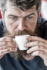 Hipster drinking coffee close up. Caffeine recharge. Man with beard and mustache and cup of coffee. Bearded guy enjoy aroma fresh espresso. Guy relaxing with espresso coffee. Coffee break concept