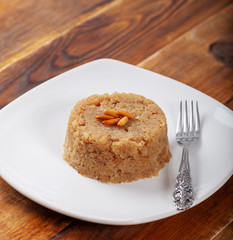 Turkish Dessert irmik helvasi / semolina with cinnamon powder and peanut