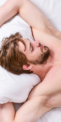 Fototapeta na wymiar Expert tips on sleeping better. Bearded man sleeping face relaxing on pillow. How much sleep you actually need. Man handsome guy lay in bed. Get adequate and consistent amount of sleep every night