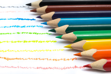 Colorful wooden pencils in row on white background