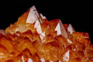 Macro mineral stone Citrine in rock in crystals on a black background