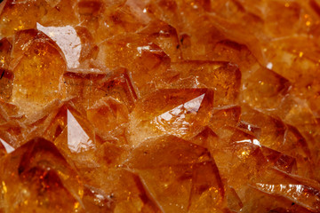 Macro mineral stone Citrine in rock in crystals on a black background