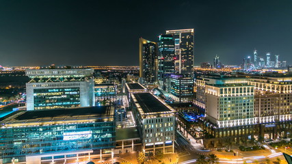 Scenic Dubai downtown architecture at night timelapse. Aerial view of  numerous skyscrapers near...