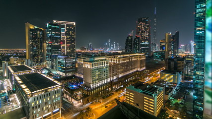 Fototapeta na wymiar Scenic Dubai downtown architecture at night timelapse. Aerial view of numerous skyscrapers near Sheikh Zayed road.