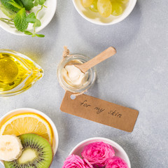Spa still life with natural ingredients for handmade cream: rose petals, herbs, oil, kiwi, banana, top view, flat lay.