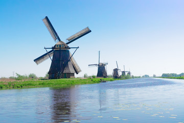Naklejka premium dutch windmill over river waters