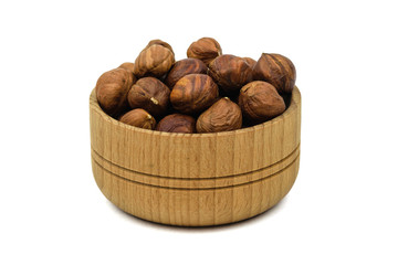 Beautiful wooden bowl with hazelnuts isolated on white background.