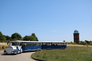 Obraz premium Tourist train and Lighthouse Peilturm at Cape Arkona on Island of Rügen, Germany Baltic Sea