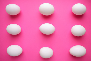 Pattern of white eggs on a pink background. Easter template