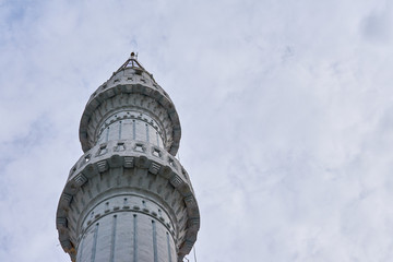                 Minaret against a cloudy sky. Copy space.               