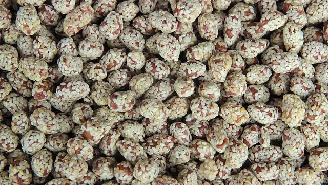 Nuts are glazed with a sesame seeds