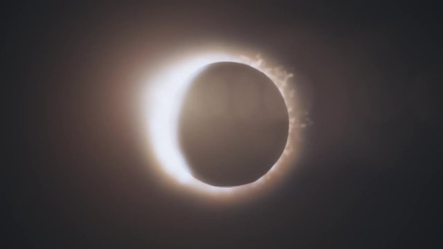 Abstract animation of eclipse of sun. Moon closes sun leaving ring of fire on black background. Animation of an astronomical phenomenon
