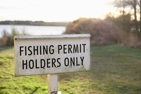 Fishing permit holders only sign at lake in Scotland
