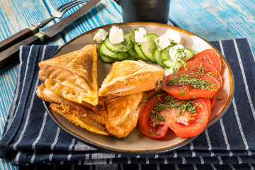 Sandwiches with cheese, tomatoes and cucumber.