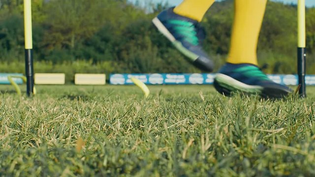 Two kids boys are training with a soccer ball on a field, 4k slow motion