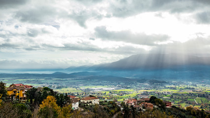 Beautiful view of the Valle del Sacco at sunset, from Anagni, Frosinone, Italy. Rays of light in the clouds, the mountains and the green valley.