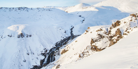 Fototapeta na wymiar Reykjadalur steam valley near Reykjavik, in Iceland with hills covered in white during winter