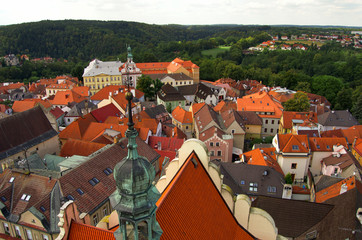 Obraz premium View from the tower in center of Tabor - summer holiday in Czech Republic. Old houses, roofs, old town, green woods, cloudy.