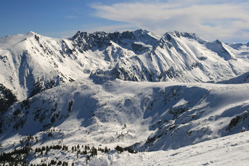 Winter landscape with hills covered with snow at Pirin Mountain, view from Todorka peak, Bulgaria
