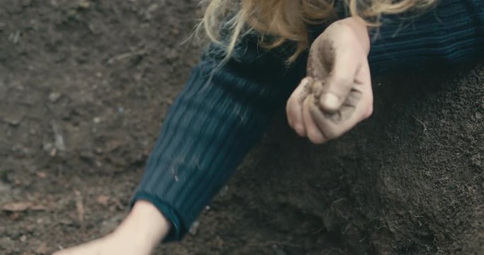 Young woman digging a hole