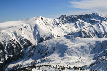 Winter landscape with hills covered with snow at Pirin Mountain, view from Todorka peak, Bulgaria