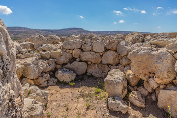 Fototapeta na wymiar Mgarr, Malta. The ruins of the Neolithic temple Ta ’Hajrat, 3800 - 3200 BC. UNESCO World Heritage List