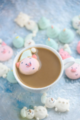 Fototapeta na wymiar Tasty and beautiful marshmallows in the form of: Christmas trees, muzzles of pigs, snowmen,