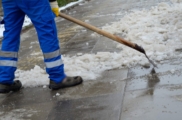 attendant shoveling snow on sidewalk -2