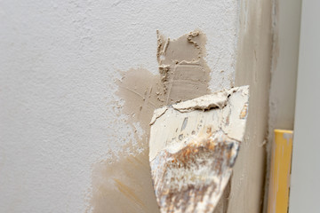 Applying putty to the wall in a new apartment. Renovation and painting of walls at home.