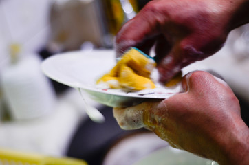 a dirty plate is hand washed 