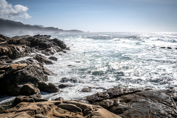 Scenic ocean view of Point Lobos State Reserve in California, near Monterey along the Pacific Coast Highway, as waves crash into the shoreline